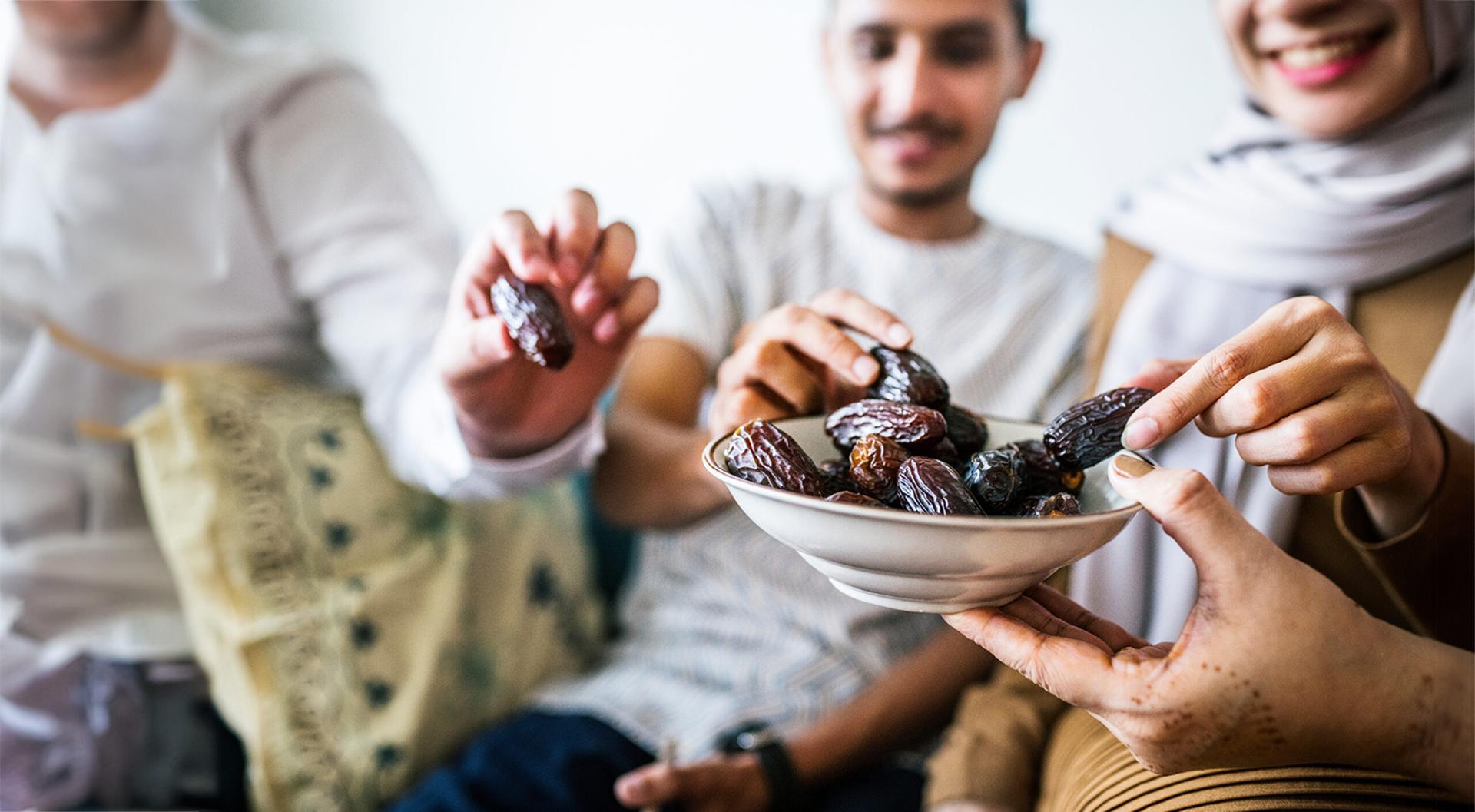 Muslim family having dried dates as a snack.