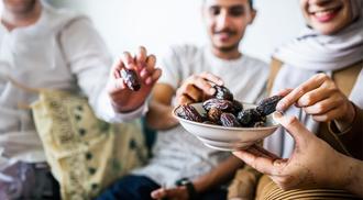 Muslim family having dried dates as a snack.