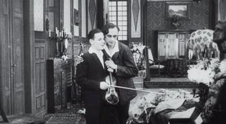 A screenshot from Anders als die Andern (Different from the Others) movie - Paul Körner hugging his younger lover.