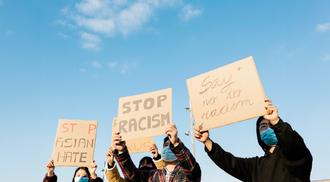 Asian people protest on the street against racism - Group of multiracial demonstrators from different asian countries fight for equal rights.