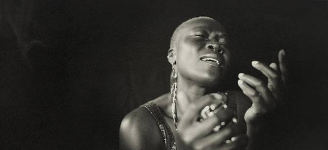Black and white portrait of a Black musician singing.