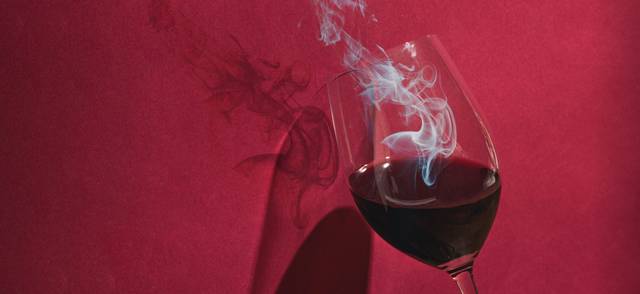 Photo illustration of fire coming out of a wine glass to illustrate smoky tasting wine