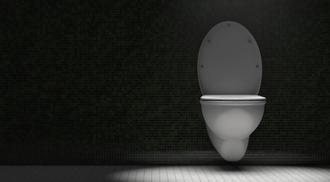 Toilet bowl in the restroom. Dramatic lighting.