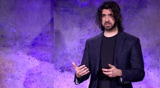 Photo of Azim Shariff on stage at TED
