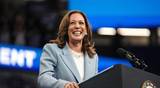 US Vice President and 2024 Democratic presidential candidate Kamala Harris smiles as she takes the podium to speak at a campaign rally in Atlanta, Georgia, on July 30, 2024.