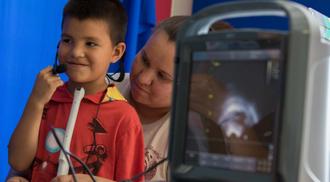 A boy and his mother work to preserve the first language of the W̱SÁNEĆ First Nation of Vancouver Island with the use of an ultrasound device
