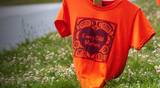 Orange shirts with the phrase &quot;Every Child Matters&quot; printed on them line Marine Drive in Vancouver as a memorial for the Indigenous children who were sent to Residential Schools in Canada.