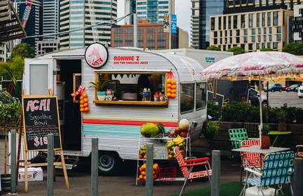 A food truck sets up in an empty urban space