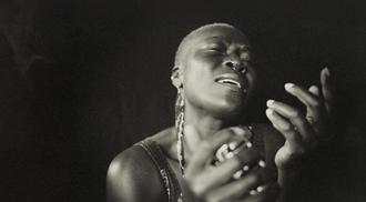 Black and white portrait of a black female musician singing.