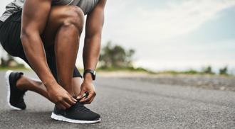 Closeup shot of a man tying shoelaces in outdoors