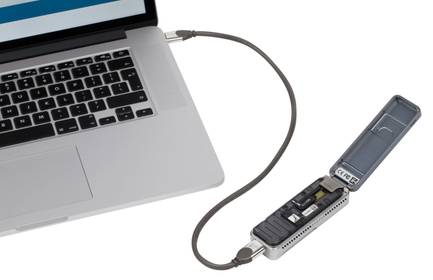 The MinION device, a small, handheld device that can sequence a person's genome, is plugged into a laptop to transfer data