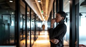 Young black business woman looking away and contemplation at work