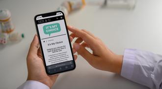 Doctor in a white coat browsing the 'It's My Choice' website.