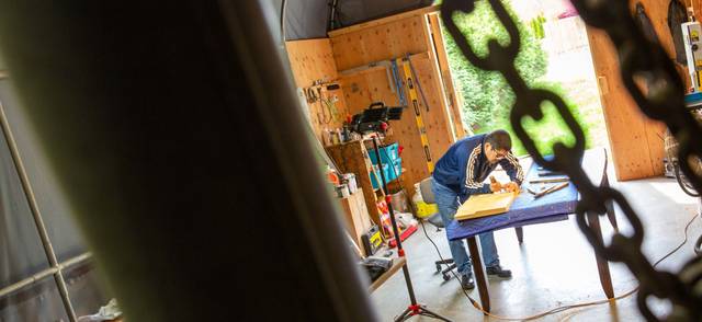 Musqueam artist Brett Sparrow carves artwork in his workshop