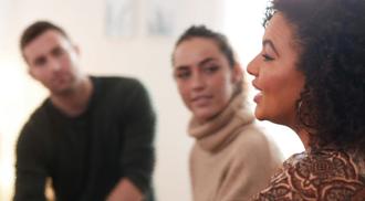 People gathered in discussion about mental health.