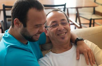 Two men embrace, showing that sexual identity and sexual behaviour do not always match