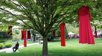 Red dresses are seen hanging on trees to commemorate missing and murdered Indigenous women and girls outside the City Hall in Vancouver, British Columbia, Canada, on May 5, 2021. May 5 is the National Day of Awareness for Missing and Murdered Indigenous Women and Girls in Canada, also known as Red Dress Day.
