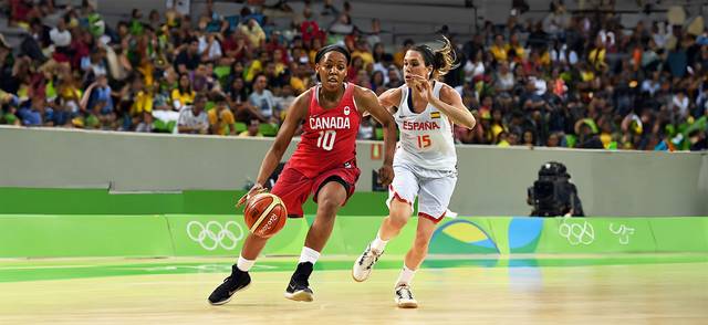 Canada's shooting guard Nirra Fields works around Spain's guard Anna Cruz during a basketball match between Spain and Canada in Rio de Janeiro during the Rio 2016 Olympic Games.